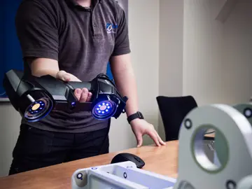 AIM ltd - Tile Image - An employee holding laser scanner scanning a product made by AIM