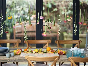 Onkoi - An image of a dressed table with a Flower Curtain And Citrus Fruit getting ready for a party